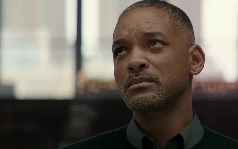Will Smith wearing a green-collared outfit.
