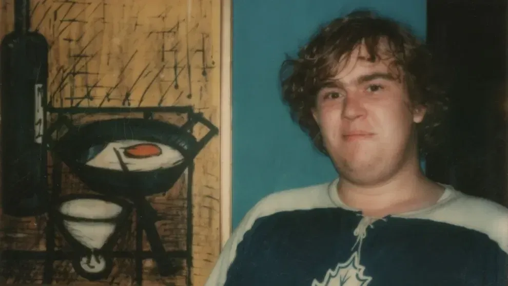 A young John Candy smiling