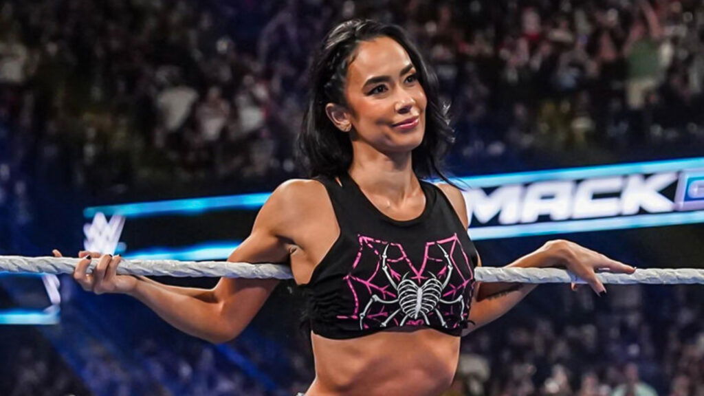 AJ Lee sitting on the ropes of the WWE ring