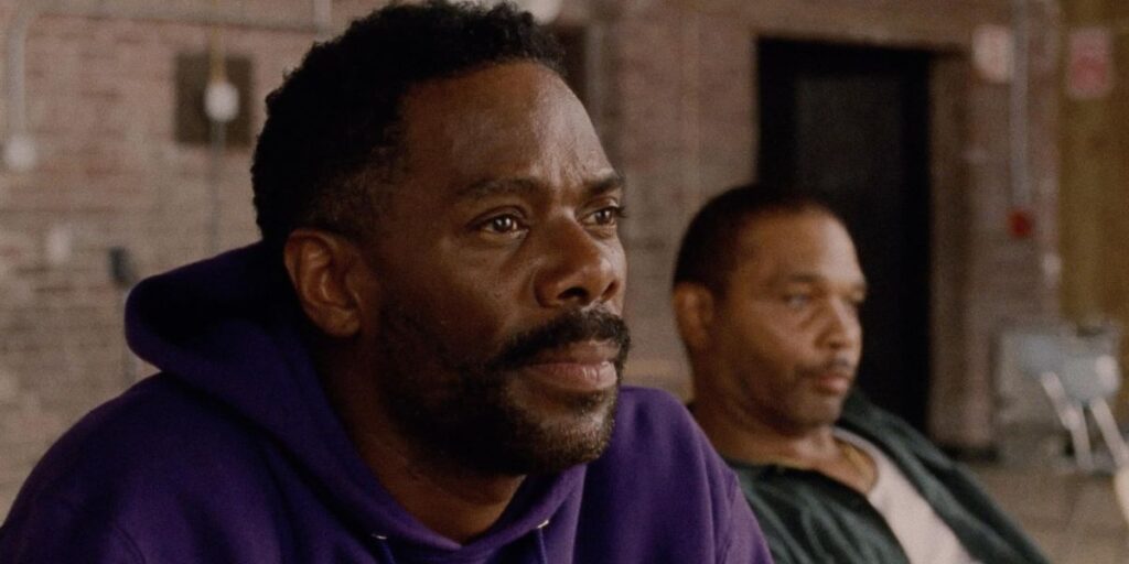 Colman Domingo in Sing Sing wearing a purple sweatshirt and looking stern. 