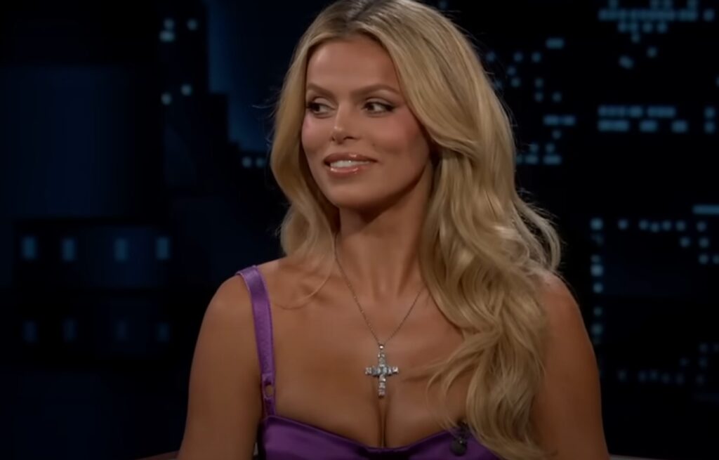 A blonde woman in a violet dress