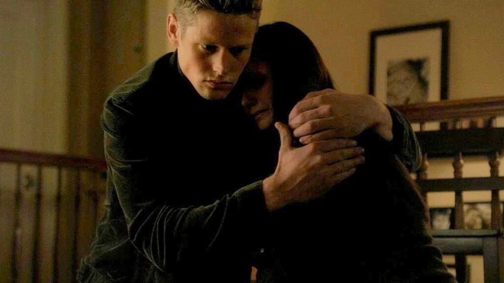 Matt embracing Elena in a home setting, both looking emotional and caring in a still from The Vampire Diaries.