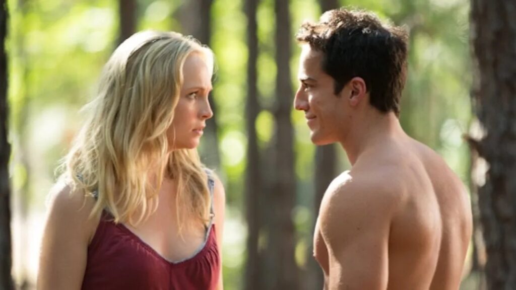 Caroline and Tyler in an outdoor scene, with Caroline in a burgundy top and Tyler shirtless, appearing to be in conversation.