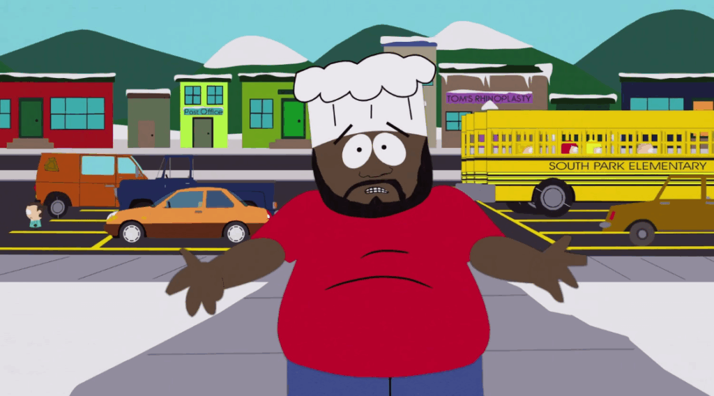 The character Chef is standing in the middle of a street in South Park, with his hands out in a gesture of confusion.
