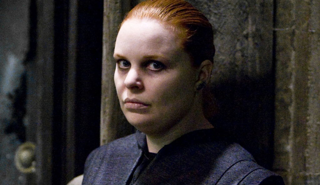 Alecto Carrow standing in Hogwarts