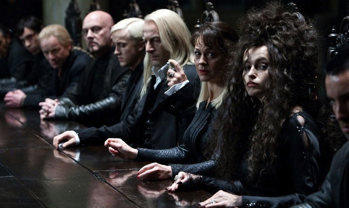Death Eaters sitting together in the Malfoy manor.
