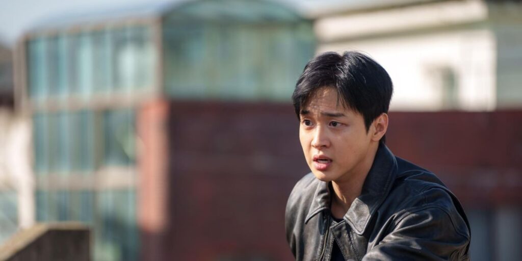 Jang Dong-yoon in Queen Mantis wearing a brown jacket and looking stressed