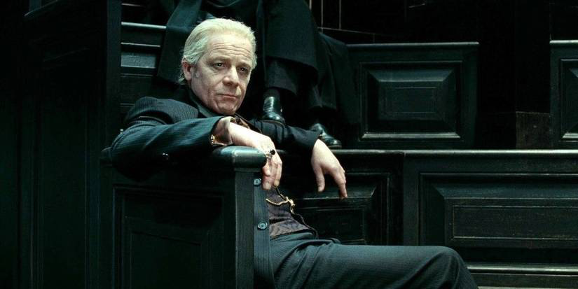 Corban Yaxley sitting relaxed in the ministry of magic.