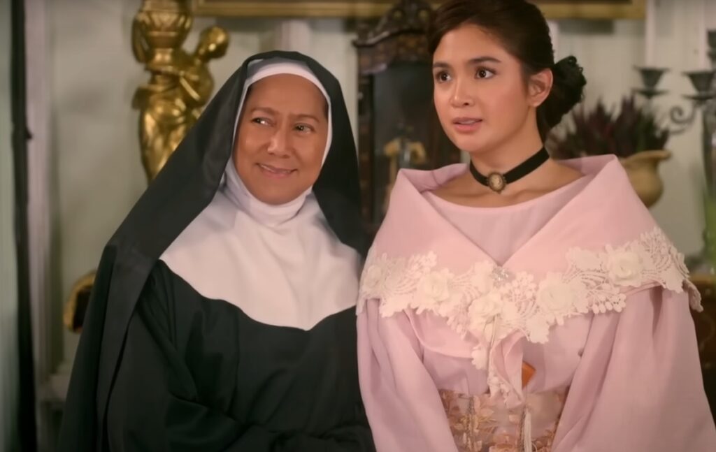 A nun and a woman standing and smiling in I Love You Since 1892