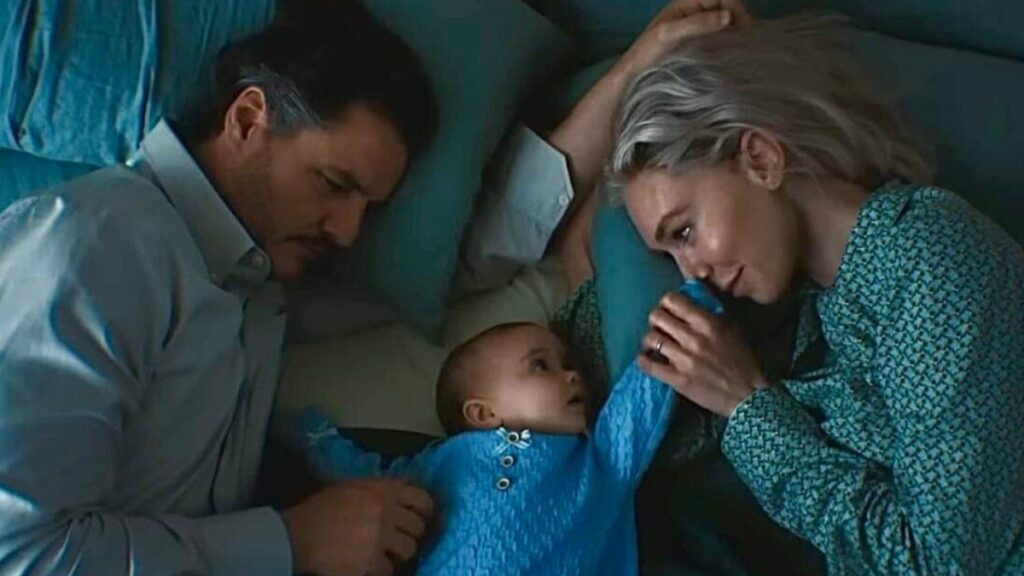 A tender scene from The Fantastic Four: First Steps showing Reed Richards and Sue Storm looking lovingly at their baby Franklin Richards.
