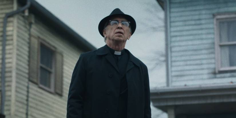 Father Gordon looking up at the Smurl house 
