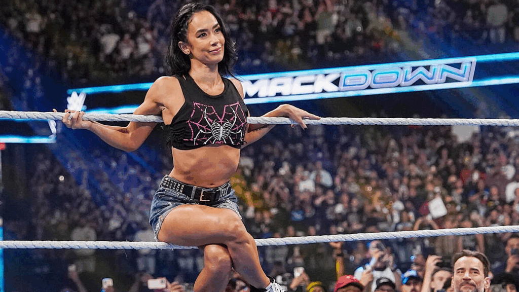 AJ Lee sitting on the ropes of the WWE ring at SmackDown