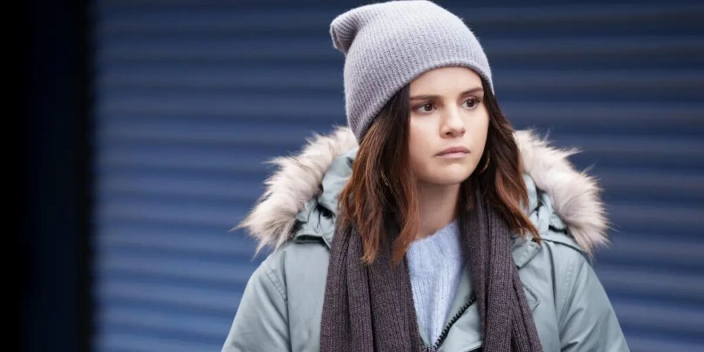 Selena Gomez as Mabel wearing a grey outfit in Only Murders In The Building