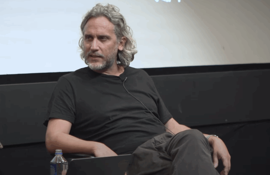 Fede Álvarez wearing a black T in an interview.
