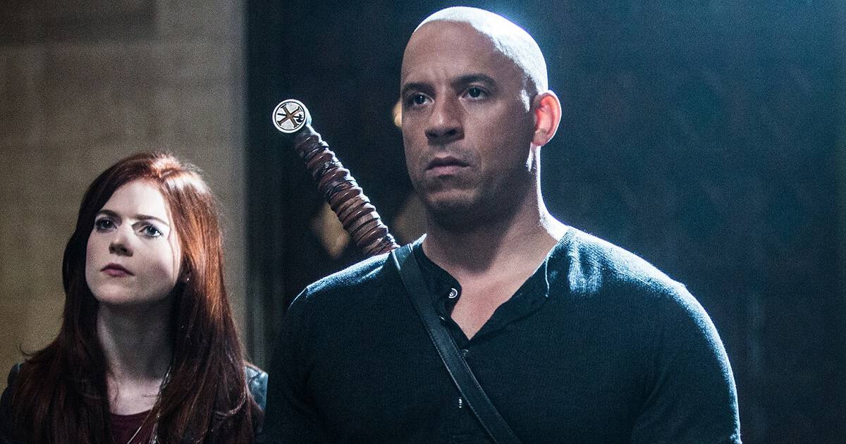Vin Diesel standing with a serious look on his face beside Rose Leslie in The Last Witch Hunter