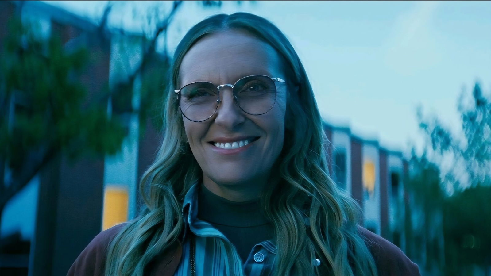 A woman awkwardly smiles