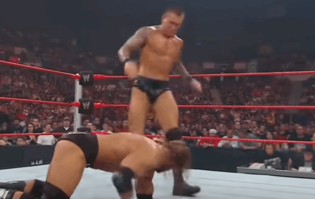 Randy Orton about to punt kick Triple H