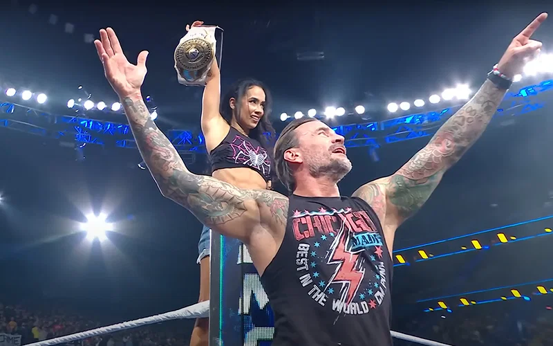 AJ Lee posing with the Women's Intercontinental Championship along with CM Punk (Smackdown, September 5, 2025)