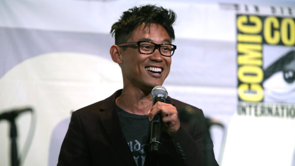 James Wan, creator and director of The Conjuring franchise, speaking enthusiastically at a microphone during a Comic-Con panel discussion