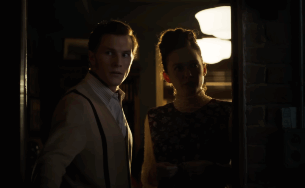 A man and a woman entering a dark room in The Conjuring: Last Rites.