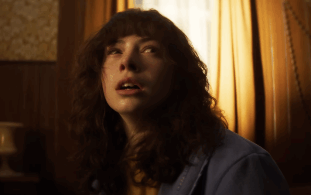 A girl with curly hair, with a terrified look on her face in The Conjuring: Last Rites.