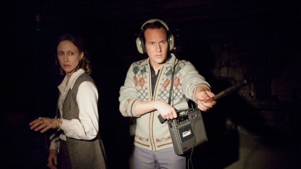 Patrick Wilson as Ed Warren and Vera Farmiga as Lorraine Warren in The Conjuring 2, using paranormal investigation equipment including recording devices during their Enfield case