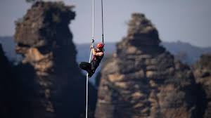 Chris Hemsworth climbing a suspended rope in Limitless