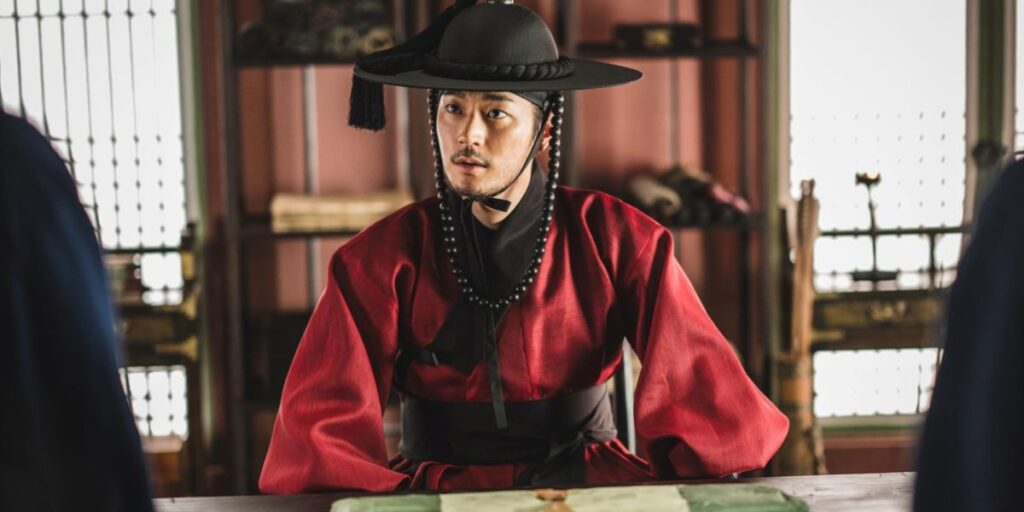 Park Seoham in a red attire looks at someone questioningly in The Murky Stream