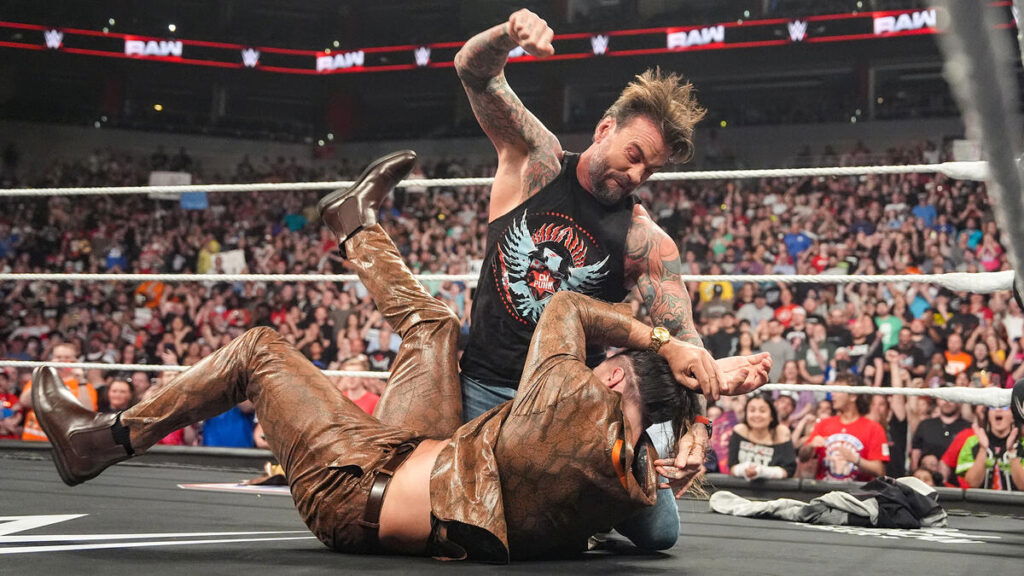 CM Punk attacking Seth Rollins during the build-up to their match at Clash in Paris.