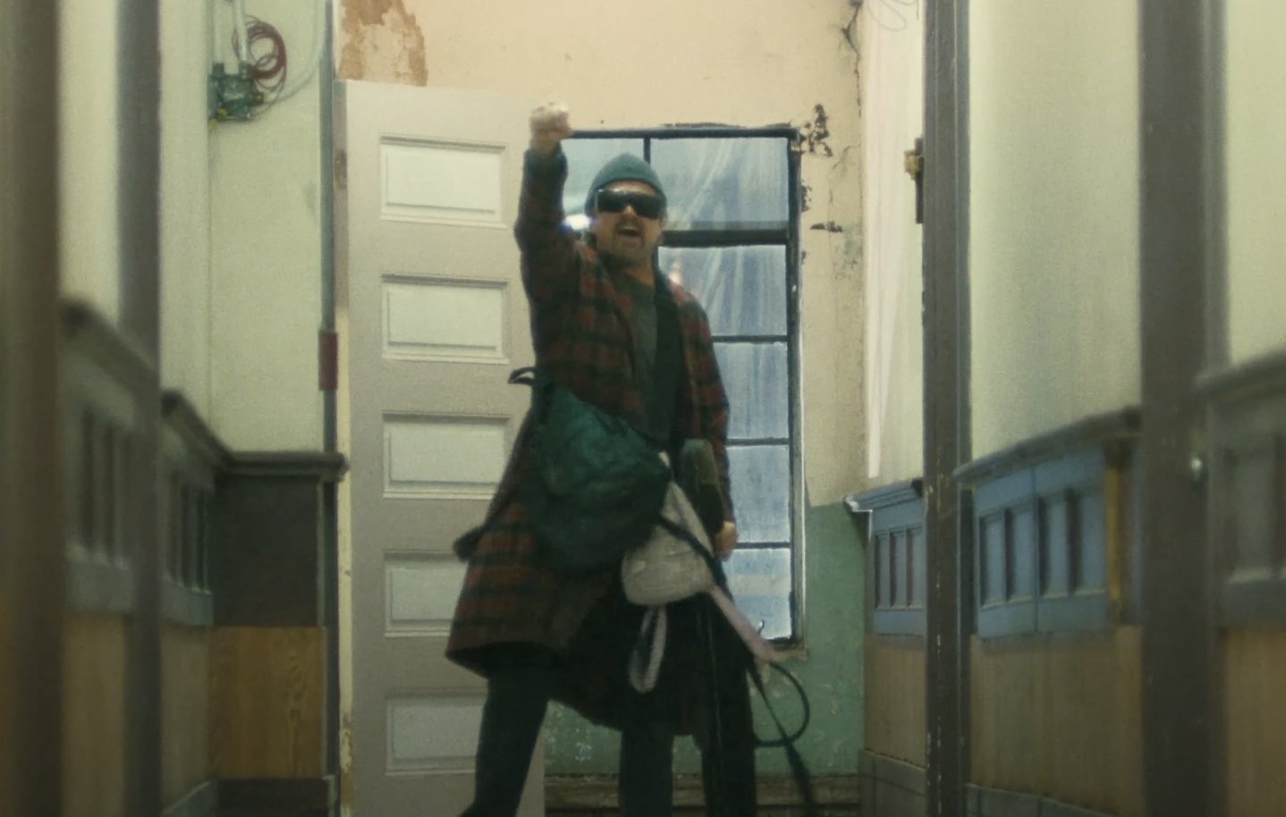 Leonardo Dicaprio yelling out a slogan in One Battle After Another