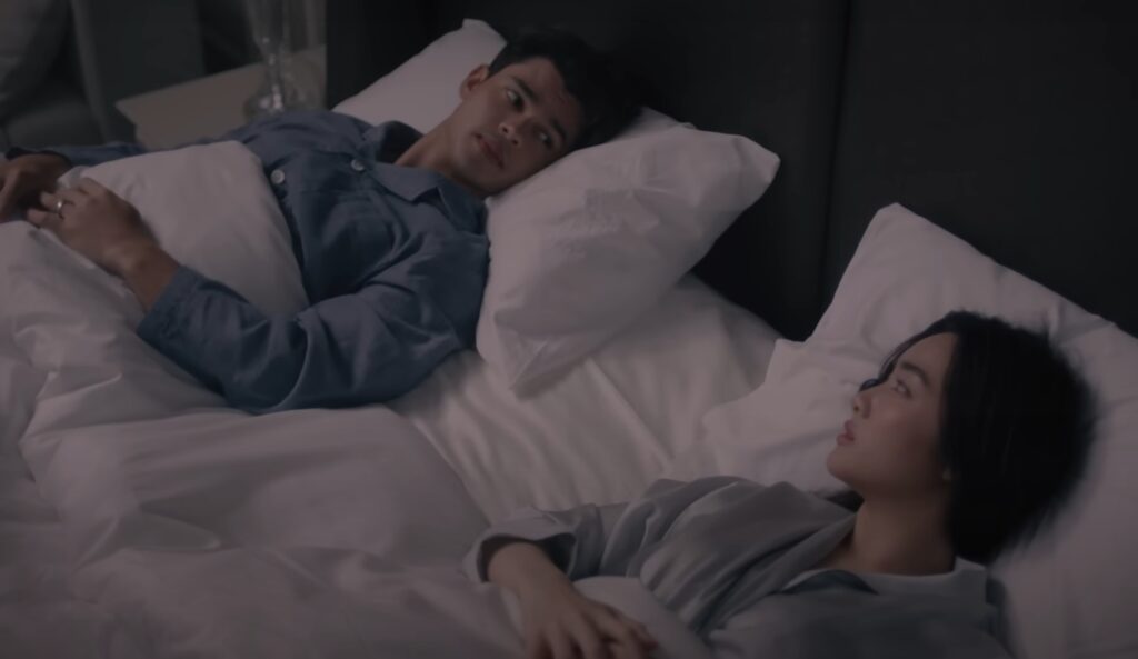 Two people sharing a bed