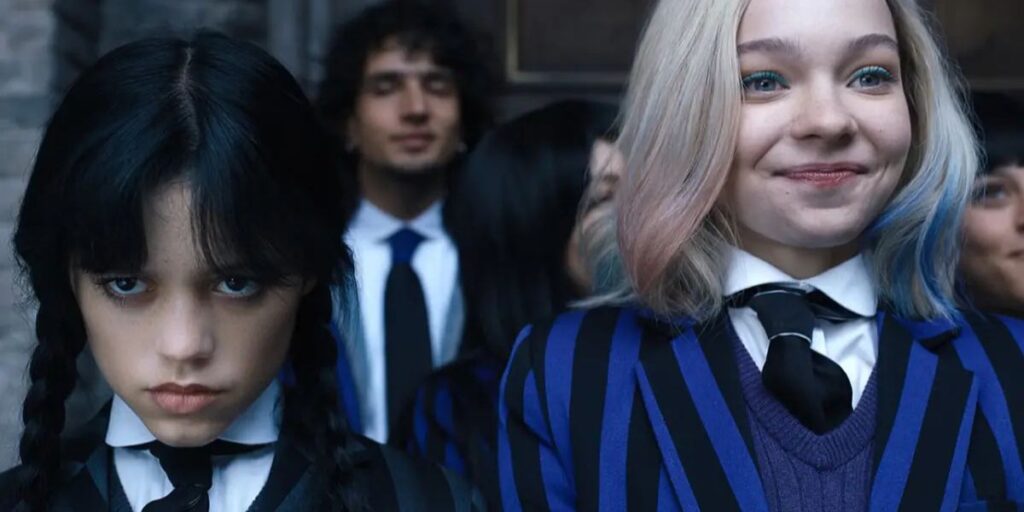 Enid Sinclair smiling and Wednesday Addams looking stern in Wednesday season 1
