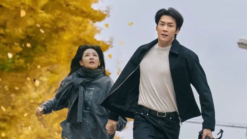 A man and a woman are running together, holding hands. 