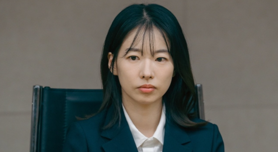 A woman with a serious expression is looking at someone.