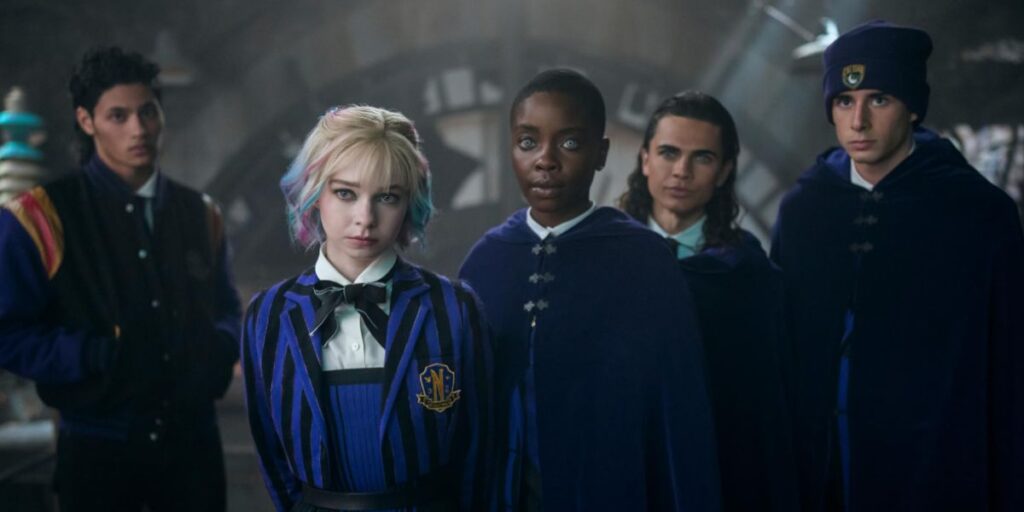 Oliver Watson, Noah B. Taylor, Emma Myers, Georgie Farmer, and Joy Sunday standing together looking stern in Wednesday
