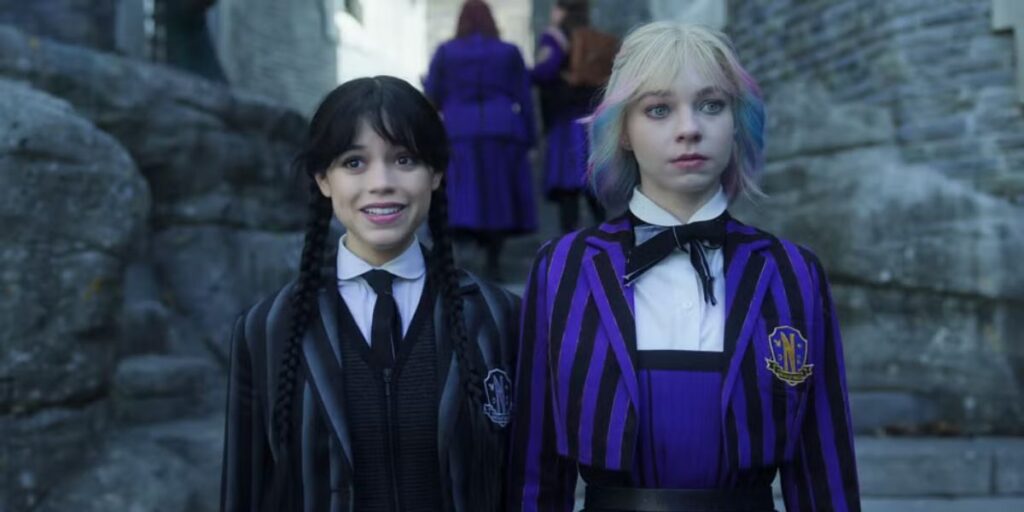 Emma Myers and Jenna Ortega standing side by side in Wednesday Season 2