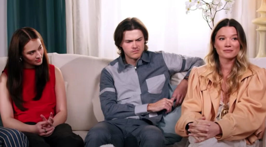The trio’s body language subtly mirrors their characters’ dynamics: playful, intense, and quietly conflicted.