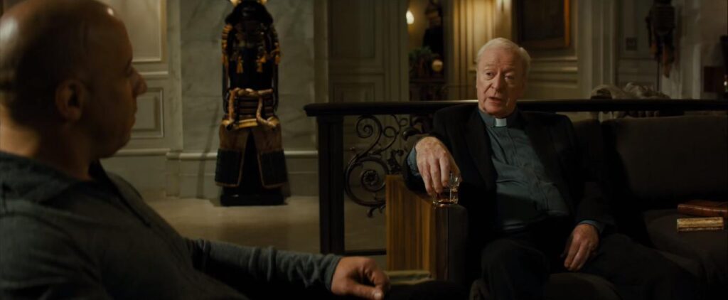 Michael Caine lounging on a chair in The Last Witch Hunter