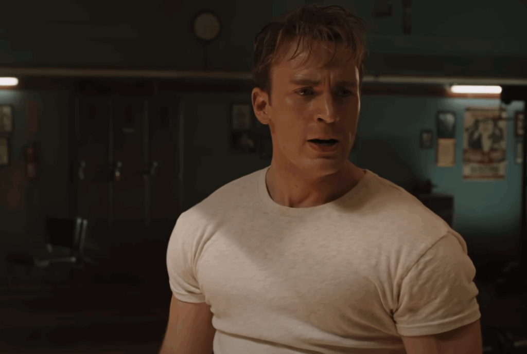 Chris Evans as Steve Rogers, weaing a plain white T-shirt. 
