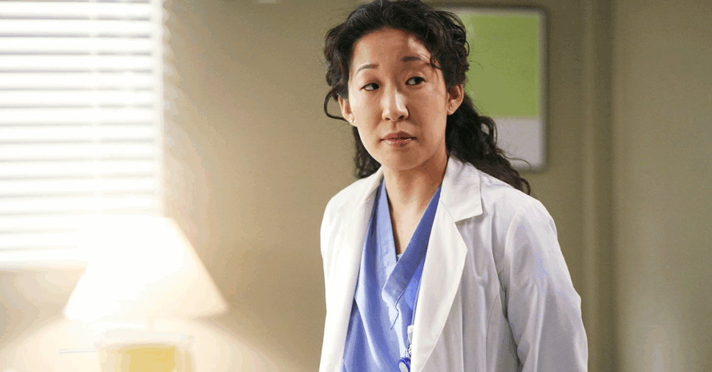 Christina Yang in her scrub looking at someone. 