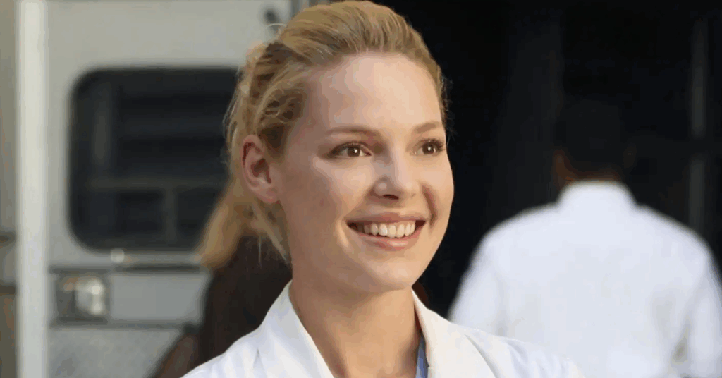 Izzie Stevens smiling at someone. 