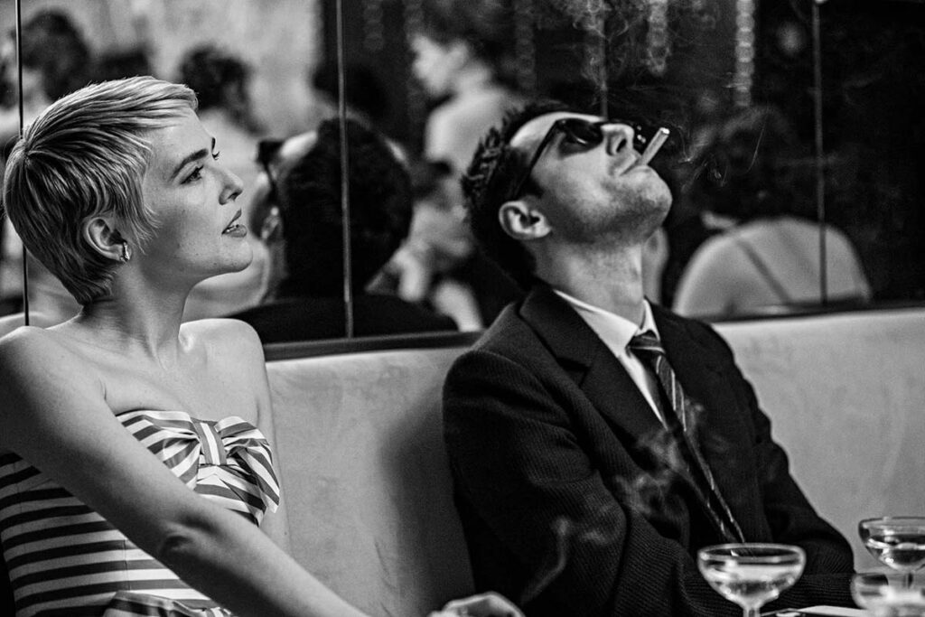 A woman looking up while a man smokes