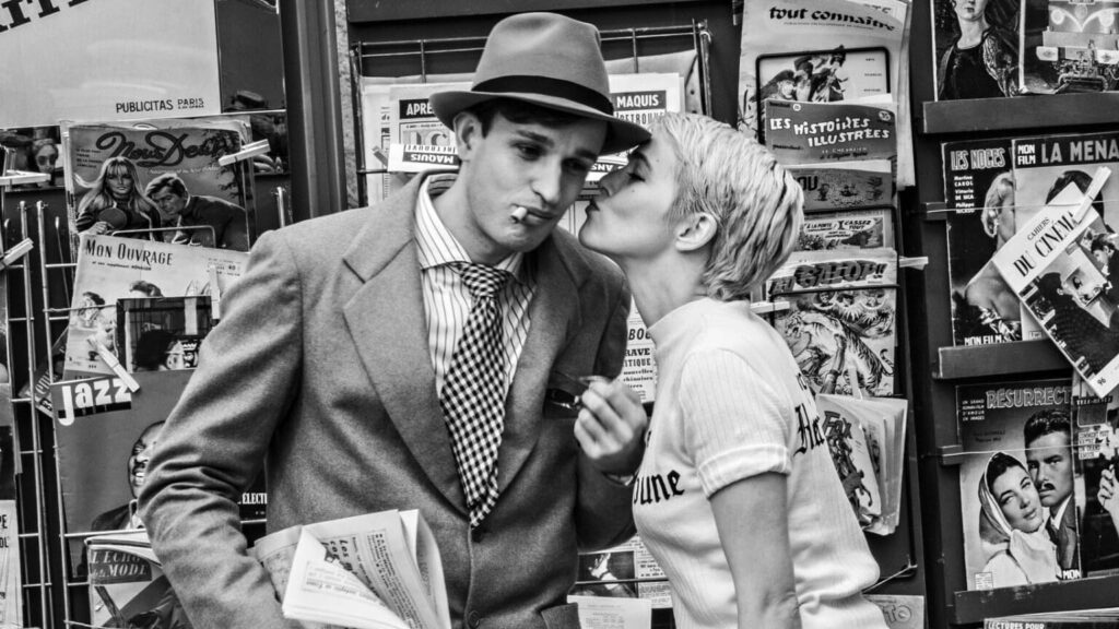 A woman kissing a man's cheek in Nouvelle Vague