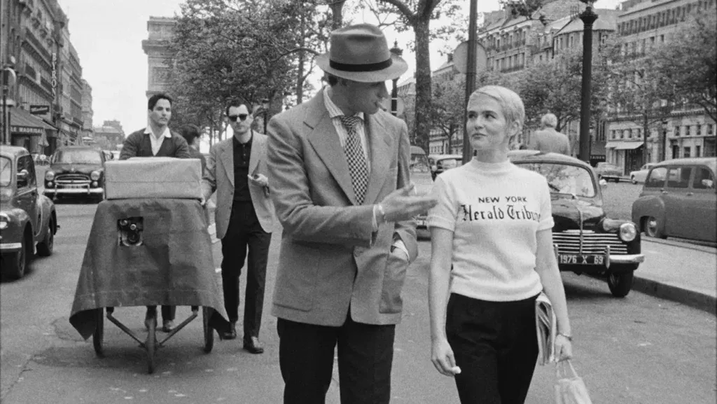 A man and a woman walking together on the road