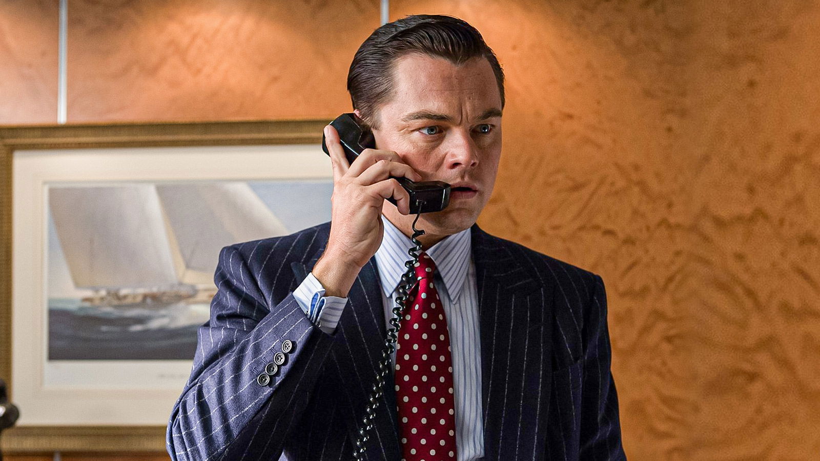 Leonardo DiCaprio talking over phone, in a suit. 