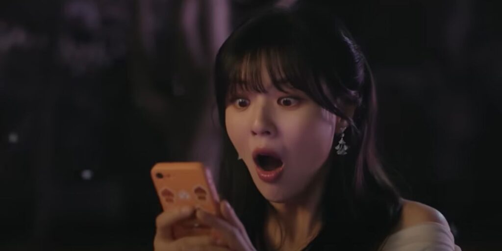 A female character looks at her phone in shock and awe in To The Moon