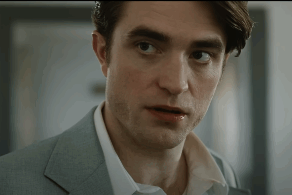 A close-up shot of Robert Pattinson's face. 