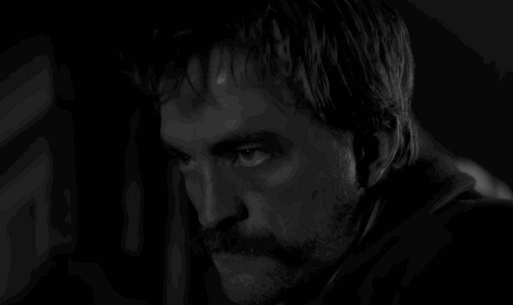 Robert Pattinson, with a long moustache in The Lighthouse.