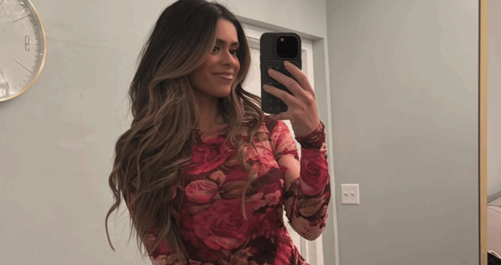 Taylor Frankie Paul taking a mirror selfie in a floral dress