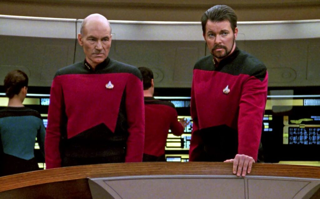 William Riker and Captain Picard on the bridge